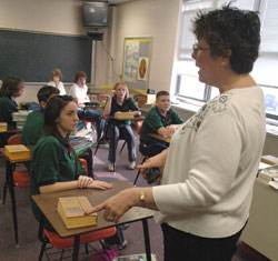 Paula Howard, Our Lady of the Greenwood middle school religion teacher, discusses “The Lost Tomb of Jesus” documentary with eighth-grade students on March 14.