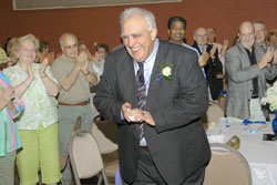 Ending his 14 years as the leader of Bishop Chatard High School, Holy Cross Brother Joseph Umile receives a standing ovation at an appreciation night for him on June 3. (Submitted photo) 