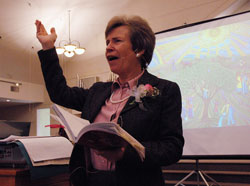 Author and inspirational speaker Kathy Coffey of Denver discusses ways to live an artful and faithful life on March 8 at St. Christopher Parish in Indianapolis. A painting by Los Angeles artist John August Swanson is displayed in the background. (Photo by Mary Ann Wyand) 