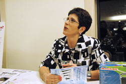 Catholic author and radio show host Teresa Tomeo of Detroit autographs a book after her keynote speech at the Catholic Radio 89.1 FM dinner on April 16 in Indianapolis. Tomeo collaborated on two books for Catholic teenagers, and also wrote books about the media influences on culture and the media’s affect on her own life. (Photo by Mary Ann Wyand) 