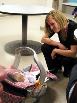 Emily Able, the director of community and youth services at Holy Family Shelter in Indianapolis, brings a smile and caring touch to her efforts to help homeless babies and children. She works with other Holy Family Shelter staff members and volunteers to help parents that are homeless begin to build a new life of hope for their families. (Photo by John Shaughnessy)