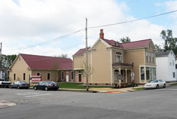 Cardinal Ritter Birthplace Foundation in New Albany held a grand opening on April 29 for its newly completed Ritter Neighborhood Resource Center, at left, behind the historic home where Cardinal Joseph E. Ritter was born. The home at 13th and Oak streets already has two agency tenants. (Photo by Patricia Happel Cornwell)