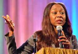 Immaculée Ilibagiza clutches a rosary as she shares her story of surviving the genocide in Rwanda in 1994 during a July 20 keynote speech at the National Black Catholic Congress in Indianapolis. Some of the proceeds from the sale of her books benefit children in Africa. (Photo by Mary Ann Garber)