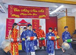 Children in traditional Vietnamese costumes perform a traditional drum dance during the Feb. 2 reception held after the Vietnamese Mass celebrating the Lunar New Year. (Photo by Natalie Hoefer)