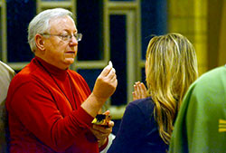 Nick Barth distributes Communion during a recent Mass at Our Lady of Perpetual Help Church in New Albany. (Submitted photo)