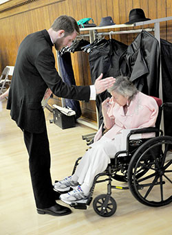 Newly ordained Father Daniel Bedel blesses Maryellen Scott, a resident of St. Augustine Home for the Aged in Indianapolis, during a reception held at the Archbishop Edward T. O’Meara Catholic Center after the priesthood ordination on June 7 at SS. Peter and Paul Cathedral in Indianapolis. Scott began praying for and corresponding with then-seminarian Bedel eight years ago when he started at Bishop Simon Bruté College Seminary in Indianapolis. (Photo by Natalie Hoefer)