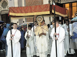 Archbishop Joseph W. Tobin carries the Blessed Sacrament from St. John the Evangelist Church in Indianapolis during a eucharistic procession at the opening of the National Catholic Youth Conference on Nov. 21, 2013. (File photo by Natalie Hoefer)