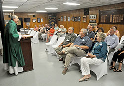 Archbishop William E. Lori laughs during a homily with members of his eighth-grade graduating class and their spouses during a July 18 Mass at a Knights of Columbus hall in New Albany. Archbishop Lori graduated from Our Lady of Perpetual Help School in New Albany in 1965. (Photo by Sean Gallagher)