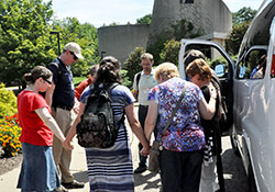 A group of catechists traveling from the Indianapolis area to the St. John Bosco conference in Steubenville, Ohio, gather for prayer before making their return journey home on July 16. (Photo by Natalie Hoefer) 