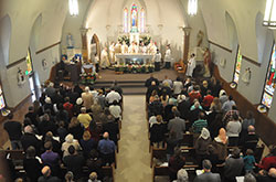 Annunciation Parish members and others from the Brazil faith community fill the church for the parish’s 150th anniversary Mass on April 4. Archbishop Joseph W. Tobin was the principal celebrant of the Mass. He was joined by concelebrants and former pastors Fathers Harold Rightor, Stephen Jarrell, Robert Hausladen, and current pastor Father John Hollowell. Also concelebrating were Conventual Franciscan Father Martin Day, pastor of St. Benedict Parish in Terre Haute, and Father Michael Fritsch, previously an Annunciation parishioner. Loral Tansy, to the right of the archbishop, served as master of ceremonies. (Photo by Natalie Hoefer)