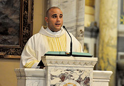 Transitional Deacon Matthew Tucci proclaims the Gospel during an Aug. 11 Mass at St. Mary Church in New Albany during an annual pilgrimage taken by archdiocesan seminarians. Deacon Tucci is scheduled to be ordained a priest on June 25 at SS. Peter and Paul Cathedral in Indianapolis. (File photo by Sean Gallagher)