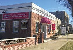 A new Women’s Care Center opened in Bloomington immediately next to a Planned Parenthood abortion facility on Feb. 1, seen in the background of this Feb. 15 photo. (Submitted photo by Lee Ann Zatkulak)	