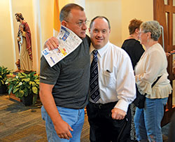 Father Todd Goodson baptizes Guadalupe Vasquez on April 15, 2017, during a celebration of the Easter Vigil at St. Monica Church in Indianapolis. The Indianapolis West Deanery faith community annually welcomes dozens of children into the full communion of the Church through the Rite of Christian Initiation of Adults adapted for children. (Submitted photo)