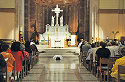 Worshippers kneel in prayer while Archbishop Charles C. Thompson lays prostrate on the floor of SS. Peter and Paul Cathedral in Indianapolis on Sept. 15 during a “Holy Hour for Prayer, Penance and Healing” for victims of sexual abuse. (Photos by Sean Gallagher)