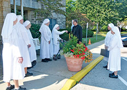 In this photo from Aug. 30, 2017, Archbishop Charles C. Thompson is welcomed by several Little Sisters of the Poor to St. Augustine Home for the Aged, which their order operates in Indianapolis. (File photo by Natalie Hoefer)