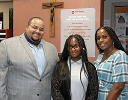 Jeff Crittendon, Braelynn Crittendon and Tiffany Underwood pose for a family photo at Holy Angels School in Indianapolis, where Braelynn is attending school with the help of Indiana’s Choice Scholarship Program, more commonly known as the voucher program. (Photo by John Shaughnessy)