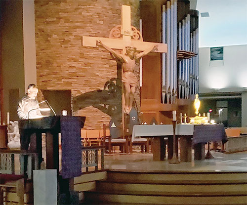 Francis Ray reads aloud from the Bible in the presence of Christ in the Blessed Sacrament in St. Malachy Church in Brownsburg early on the morning of March 12 as part of the parish’s The Word Became Flesh Bible Marathon from March 10-14, an event designed to highlight Christ’s presence in the word and in the Eucharist. (Photo by Natalie Hoefer)