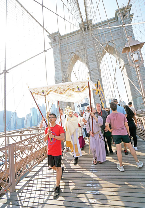 Bishop Robert J. Brennan of Brooklyn, N.Y., carries a monstrance while leading a eucharistic procession across the Brooklyn Bridge to Brooklyn from Manhattan on the National Eucharistic Pilgrimage’s St. Elizabeth Ann Seton (East) Route on May 26. (OSV News photo/Gregory A. Shemitz, The Tablet)