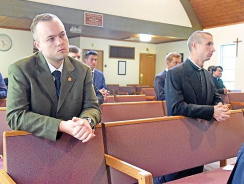 Seminarians Aidan Hauersperger, left, and Isaac Siefker kneel in prayer on Aug. 12 during a Mass at Our Lady of Fatima Retreat House in Indianapolis during the annual archdiocesan seminarian convocation. (Photo by Sean Gallagher)