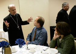 Bishop Dale J Melczek speaks with Deacon Christopher Hawkins at the reception following the annual anniversary Mass for deacons of this diocese. (Tim Hunt photo)