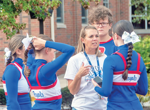 Roncalli High School’s head cheerleading coach Jessica Engel talks with members of the Indianapolis school’s cheerleading squad for the Sept. 6 football game against Bishop Chatard High School in Indianapolis. (Submitted photo)